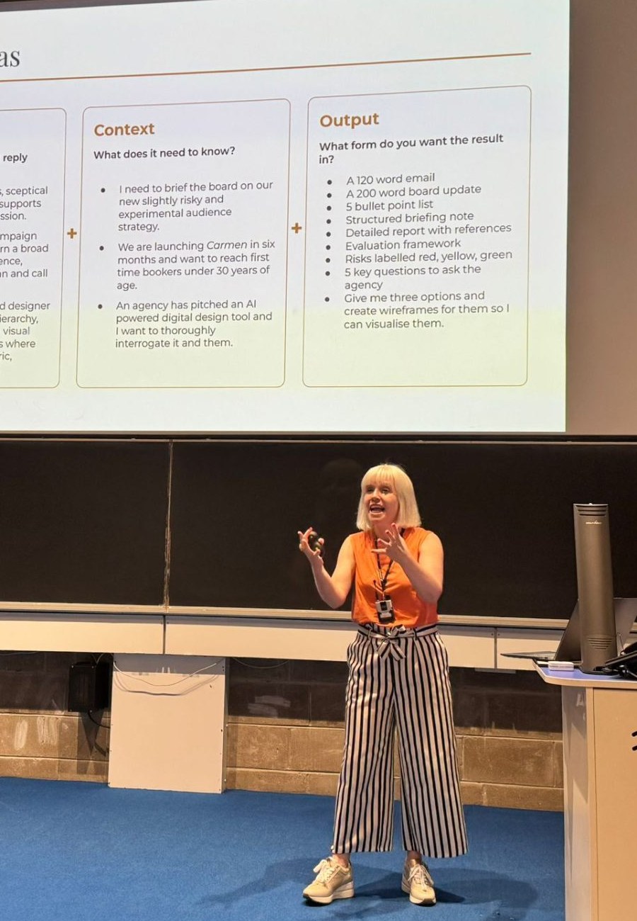 Brooke Gallagher standing at the front of a Trinity College Dublin lecture room, in conversation with seated training participants.